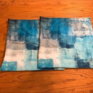 Two piece set of pillow covers.  Main color is teal with other blues and white